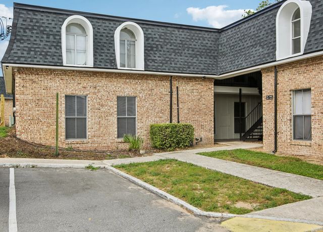 Close view of the arched windows and brick facade