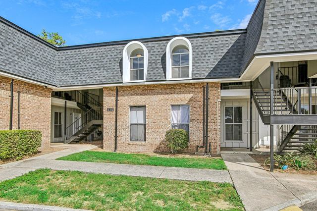 Brick apartment buildings with arched dormer windows at Grand Oaks